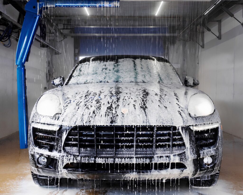 Porsche covered in foam inside a Water Works Touch Free automatic car wash bay